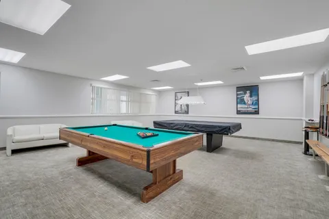 a room with pool tables and furniture