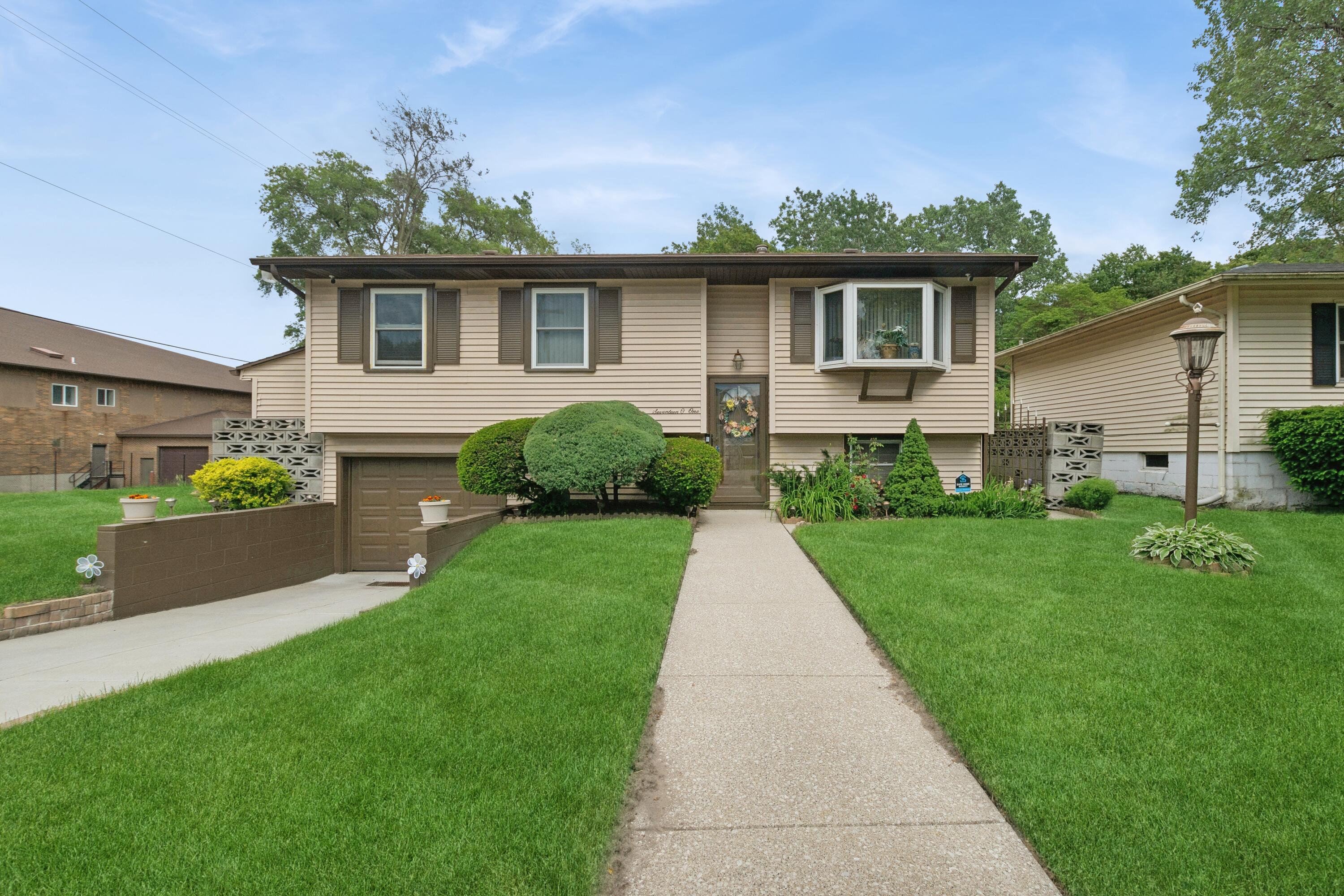 1701-1707 Mount Street Gary, IN 46404 - Photo 1 of 18 a front view of a house with a yard and potted plants