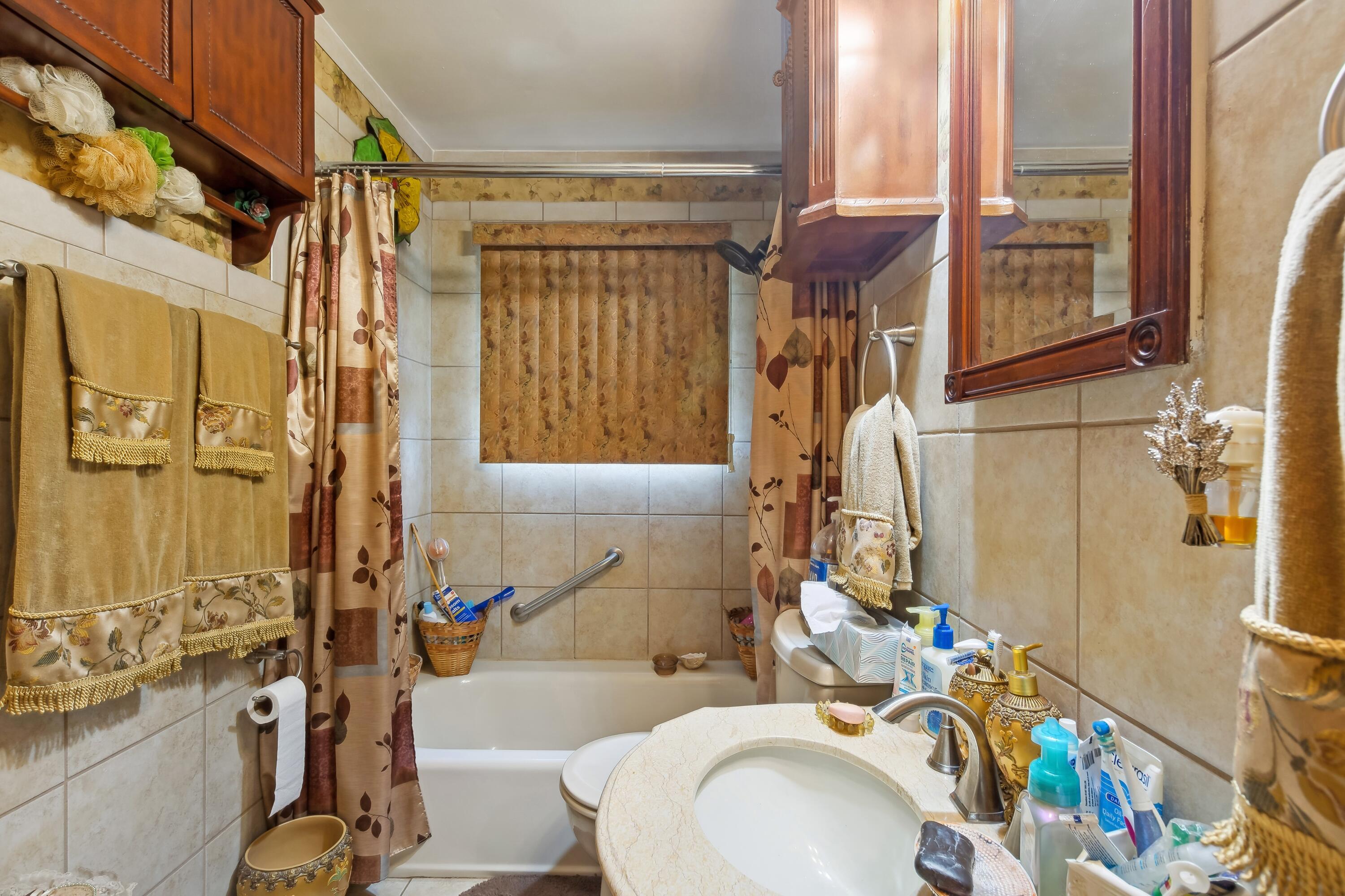 1701-1707 Mount Street Gary, IN 46404 - Photo 11 of 18 a bathroom with a sink toilet and shower