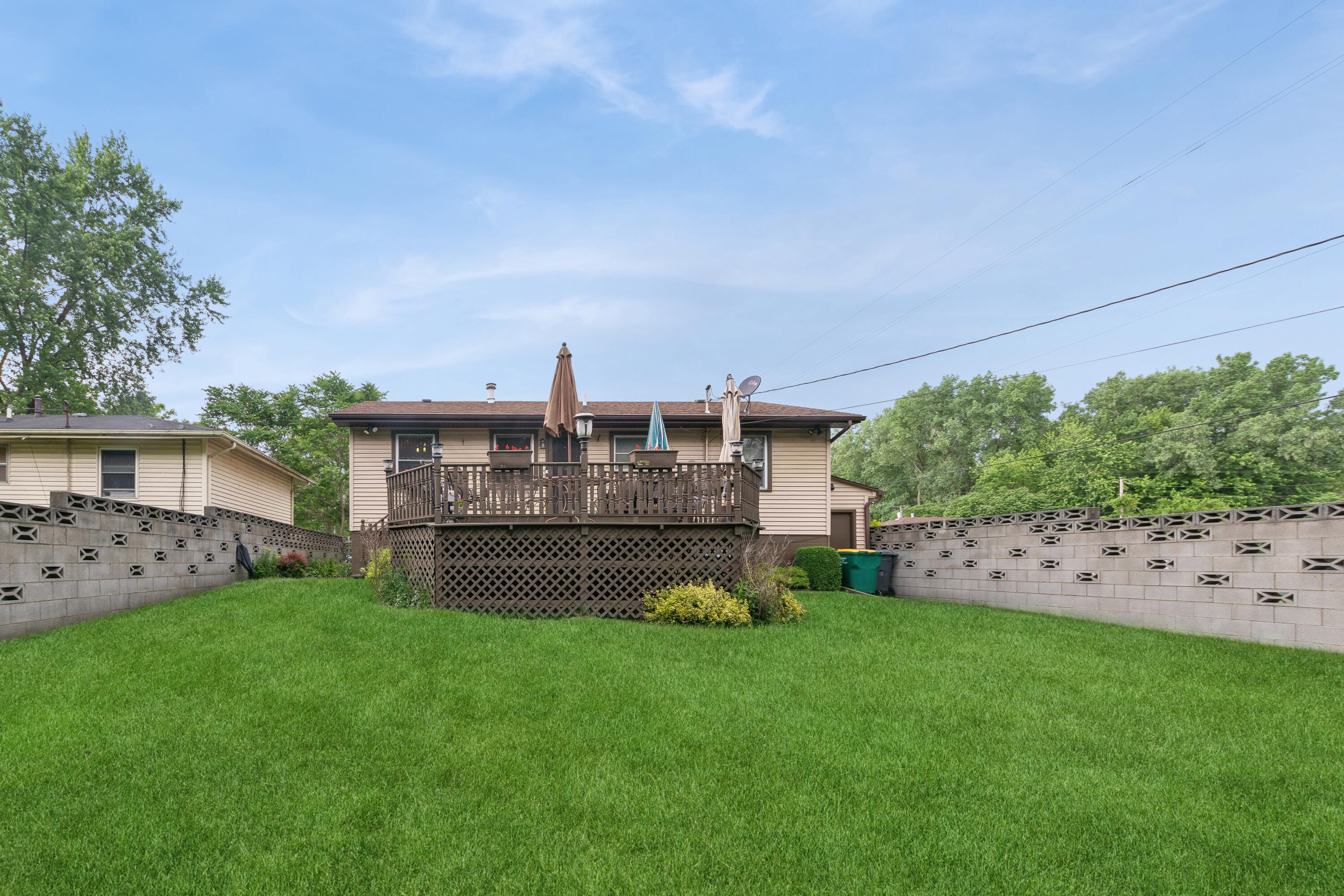 1701-1707 Mount Street Gary, IN 46404 - Photo 18 of 18 a view of a house with a garden and plants