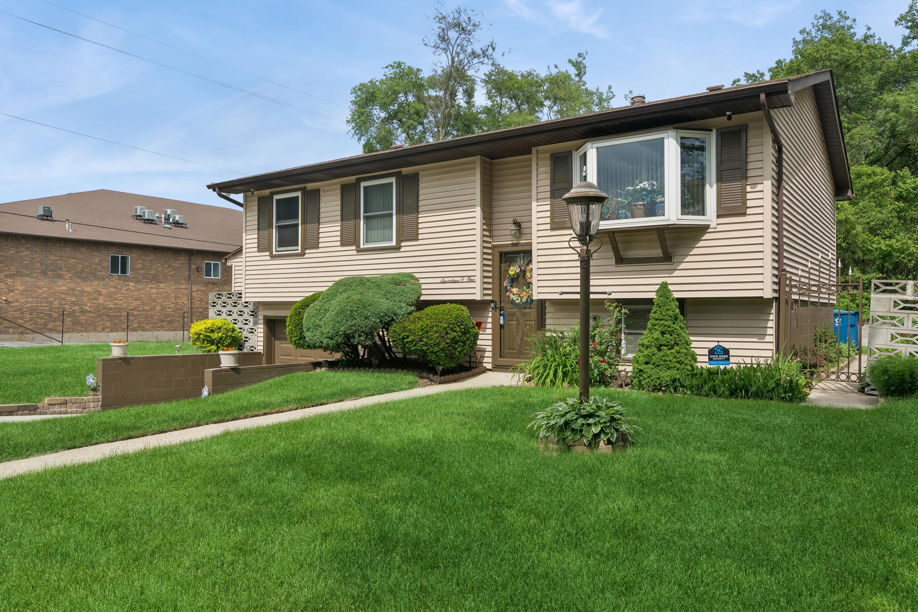1701-1707 Mount Street Gary, IN 46404 - Photo 3 of 18 a front view of a house with a garden