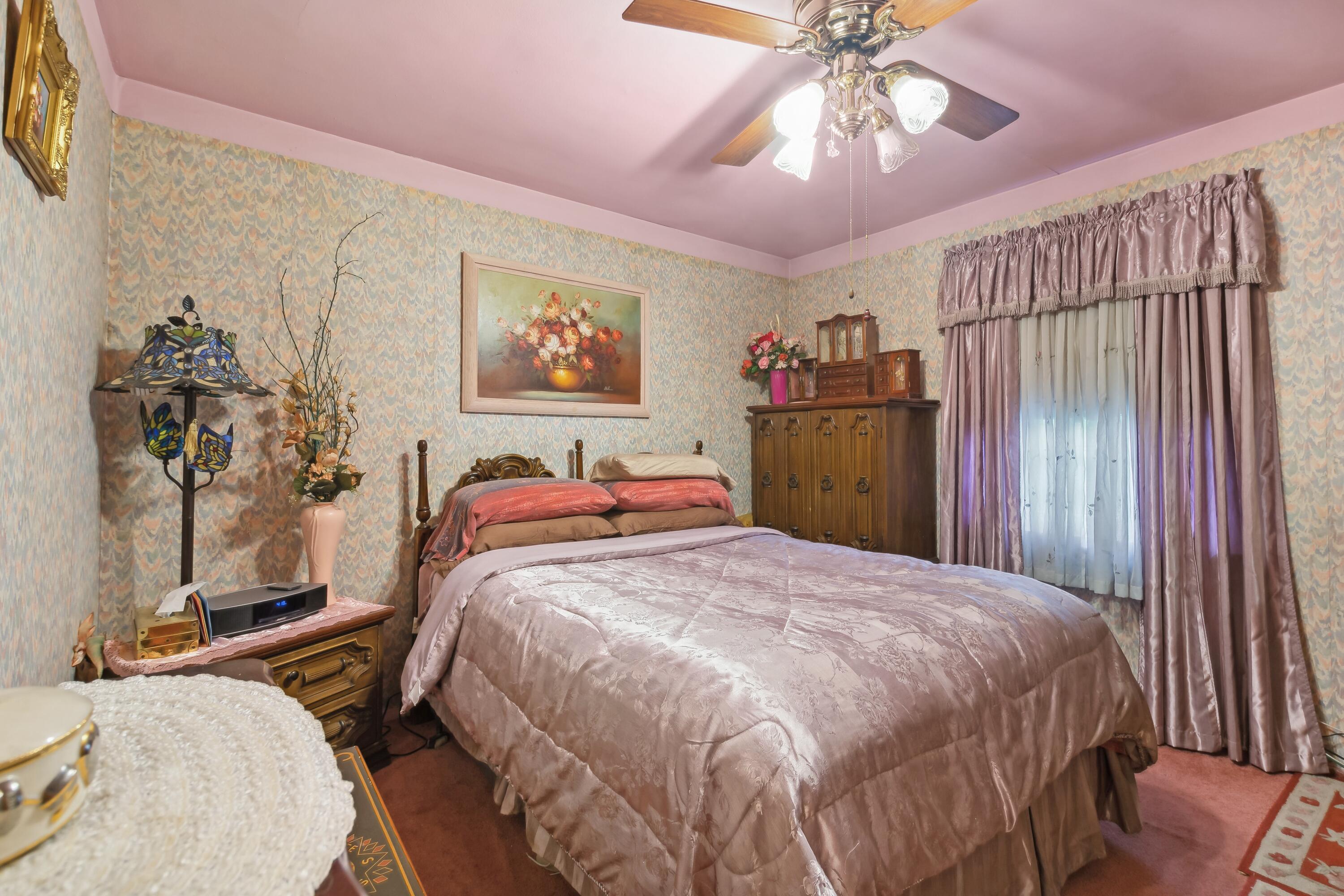 1701-1707 Mount Street Gary, IN 46404 - Photo 9 of 18 a bedroom with a bed and a chandelier