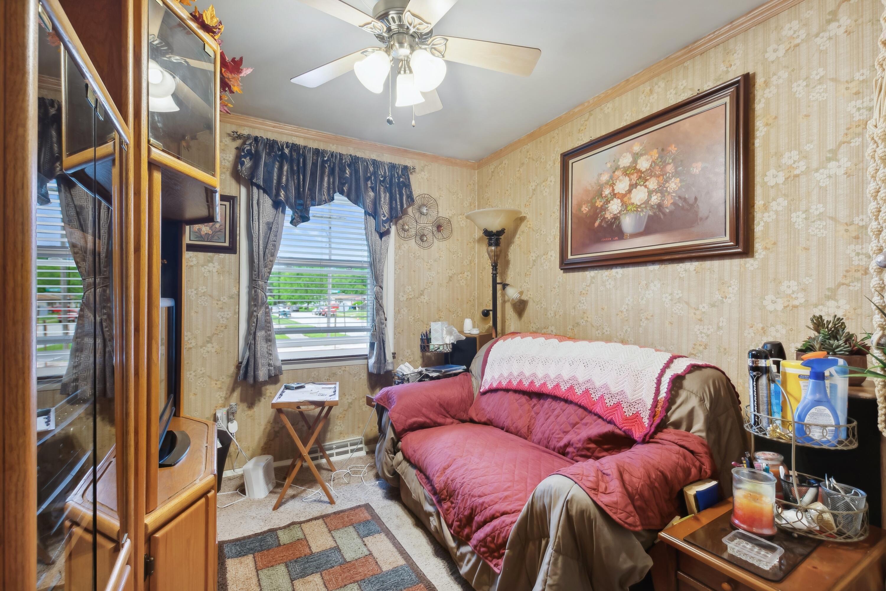 1701-1707 Mount Street Gary, IN 46404 - Photo 10 of 18 a bedroom with furniture and a large window