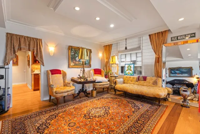 a living room with furniture a rug and a flat screen tv