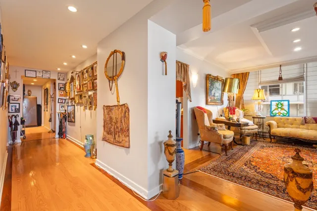 a living room with furniture a rug and a chandelier
