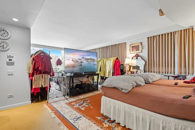 a bedroom with two bed and a window