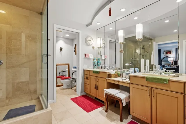 a room with kitchen island a sink appliances and cabinets