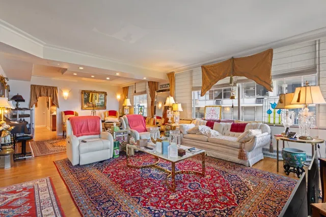 a living room with furniture a rug and wooden floor