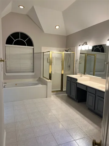 a bathroom with a double vanity sink a large mirror and shower