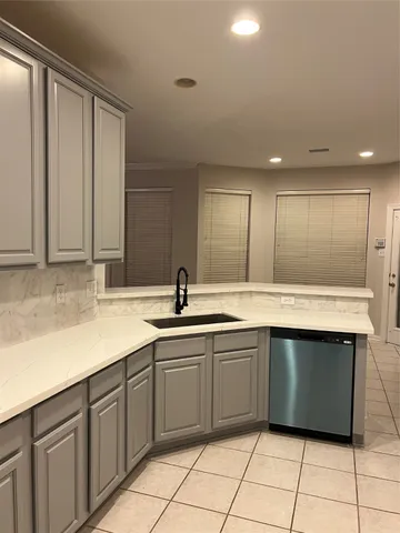 a large kitchen with a sink and cabinets
