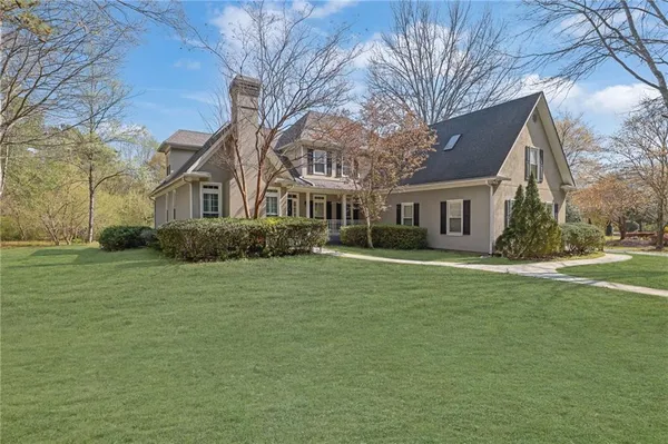 a front view of a house with a garden