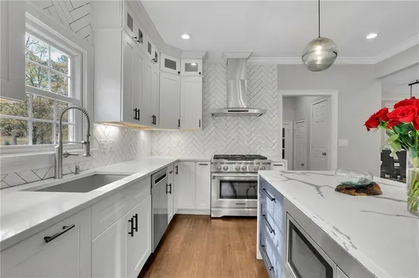a kitchen with a sink stove and refrigerator
