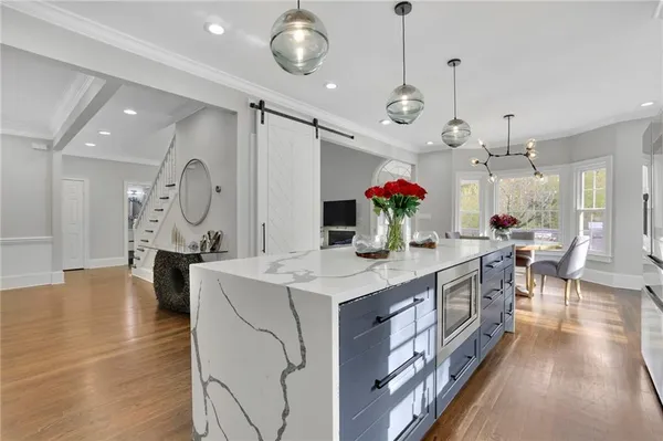 a large kitchen with stainless steel appliances kitchen island a large island in the center