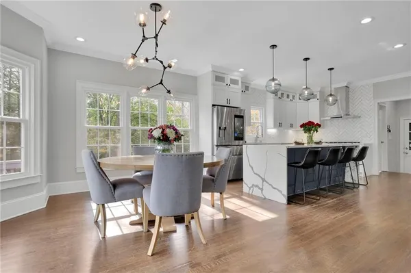 a view of a dining room with furniture window and wooden floor