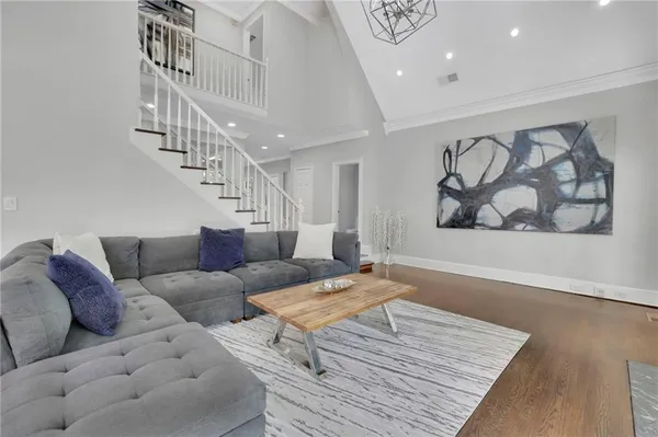 a living room with furniture and stairs