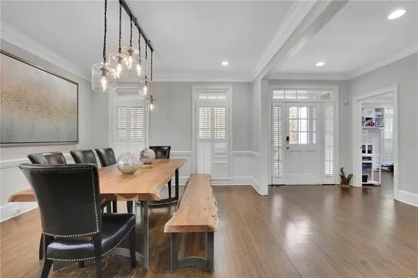 a view of a dining room with furniture wooden floor and chandelier