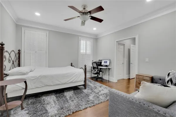a bedroom with a bed a couch and a dresser