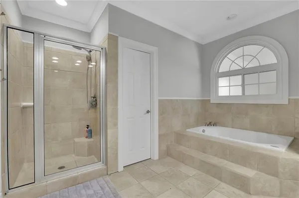 a spacious bathroom with a bathtub and a shower