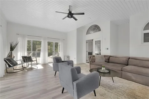 a living room with furniture a fireplace and a chandelier
