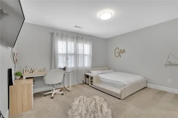 a bedroom with a bed and a table in it