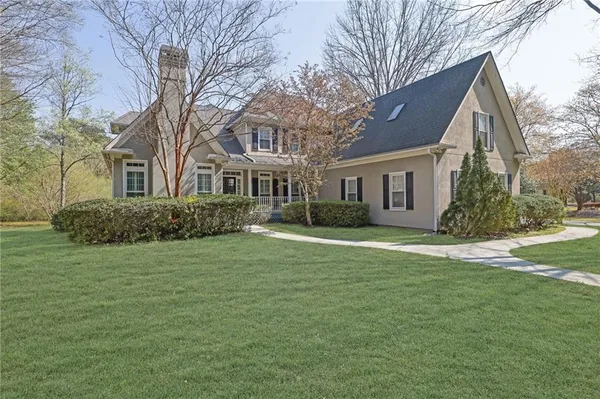 a front view of a house with a garden