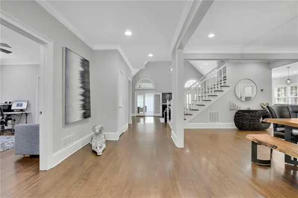 a living room with furniture and a wooden floor