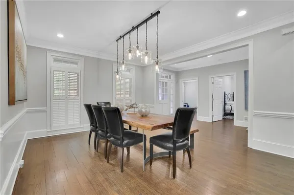 a view of a dining room with furniture and wooden floor