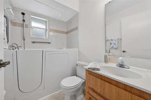 a view of a livingroom with a ceiling fan and window