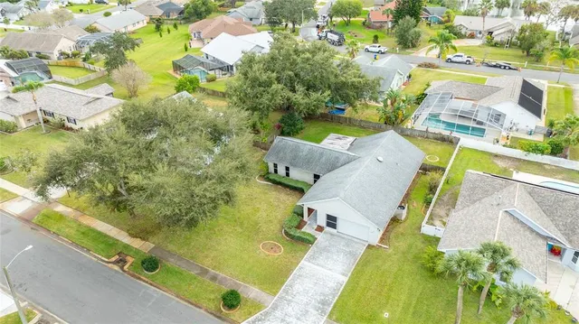 a kitchen with stainless steel appliances granite countertop a refrigerator a stove top oven a sink dishwasher and white cabinets with wooden floor