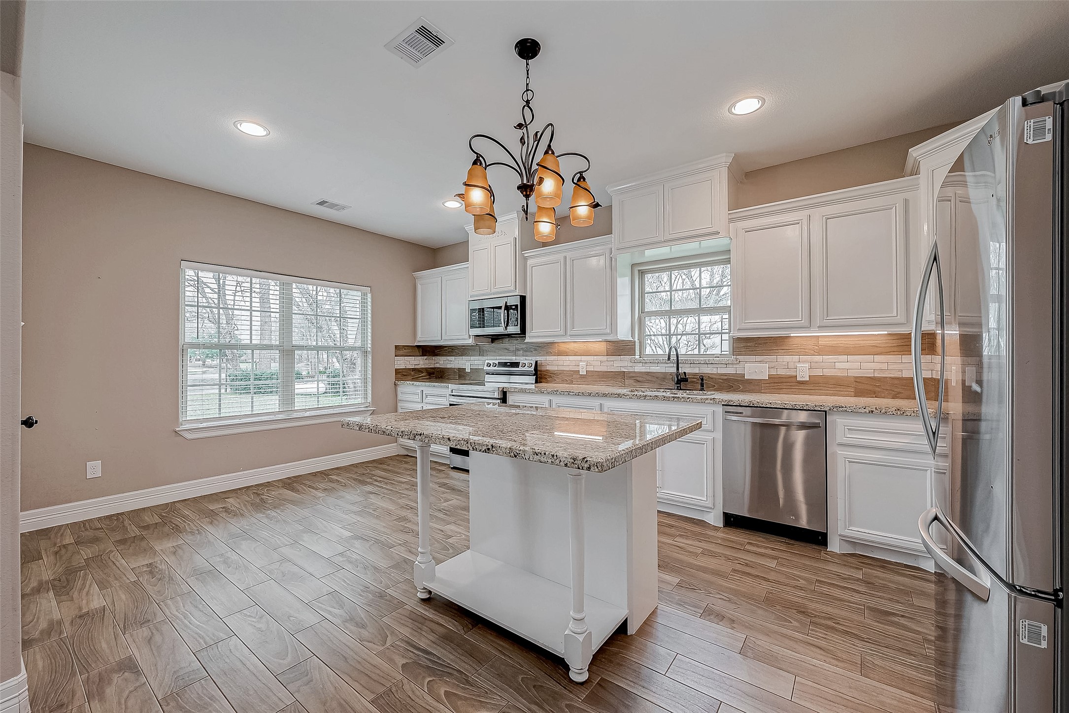 11 Bluebonnet Trinity, TX 75862 - Photo 13 of 46 a kitchen with kitchen island granite countertop a sink cabinets and wooden floor