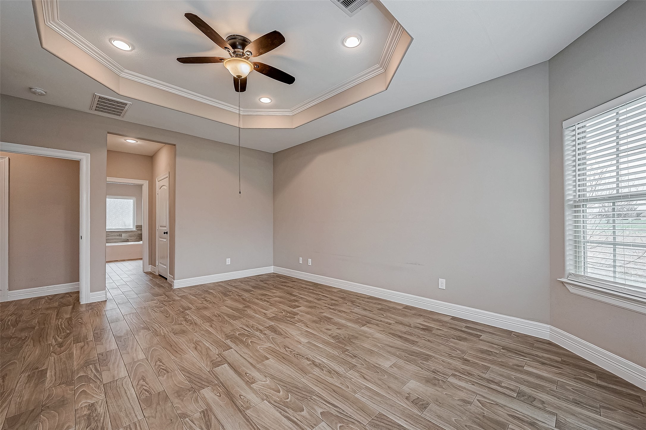 11 Bluebonnet Trinity, TX 75862 - Photo 17 of 46 an empty room with wooden floor and windows