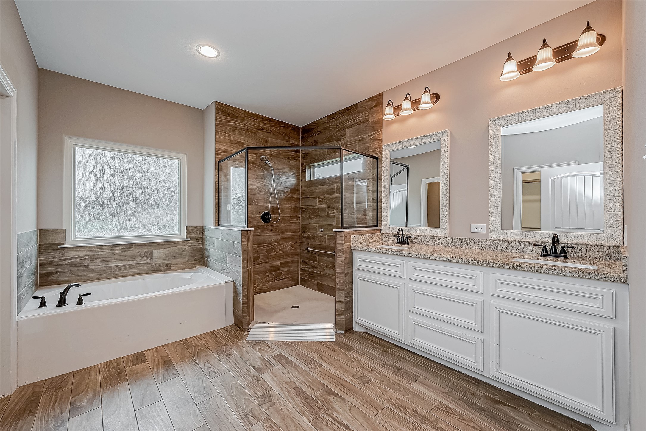 11 Bluebonnet Trinity, TX 75862 - Photo 19 of 46 a spacious bathroom with a tub sink shower and mirror