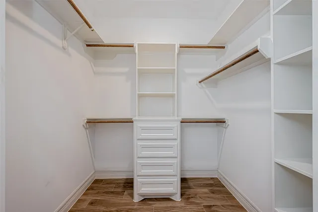a view of walk in closet with empty racks