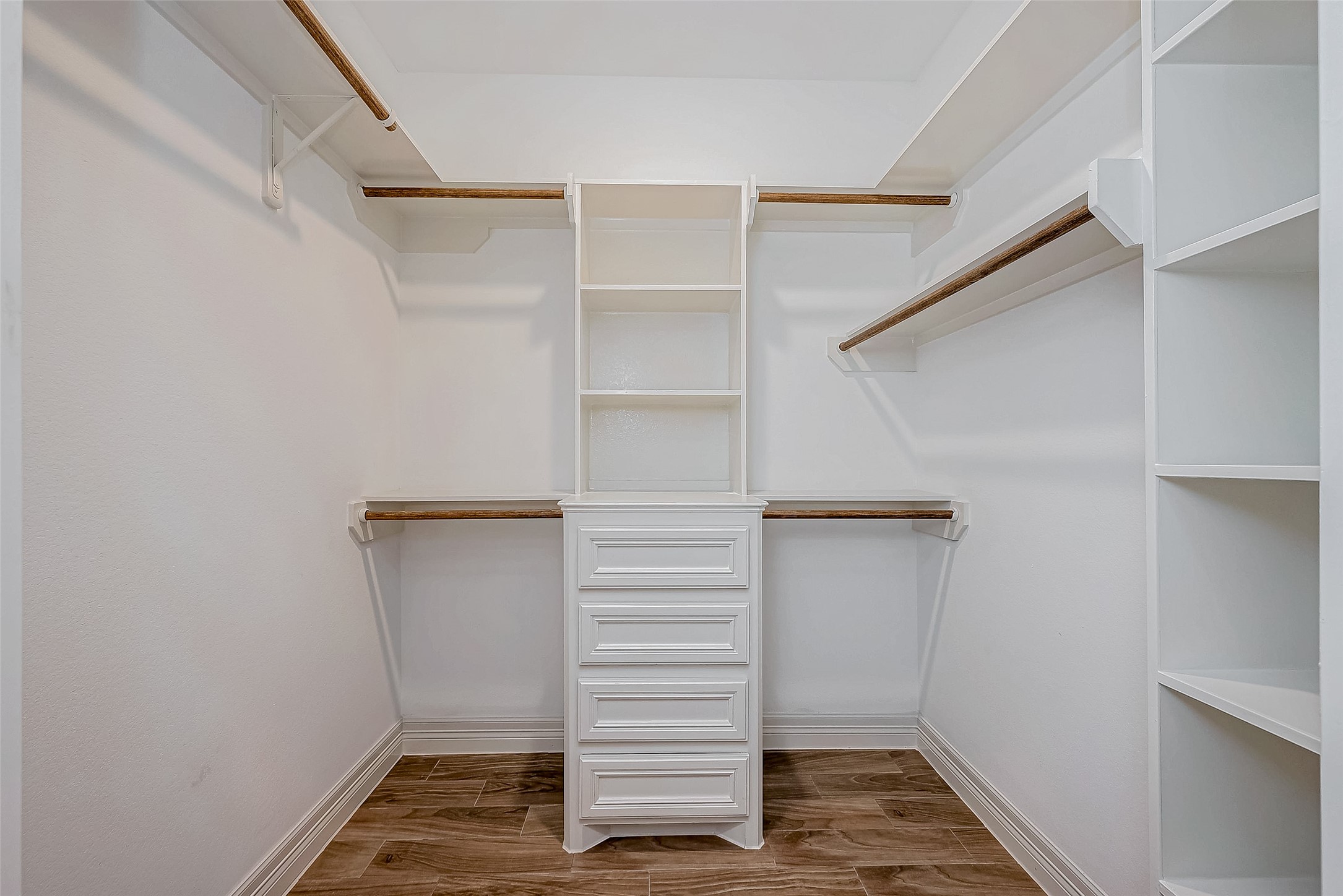 11 Bluebonnet Trinity, TX 75862 - Photo 22 of 46 a view of walk in closet with empty racks
