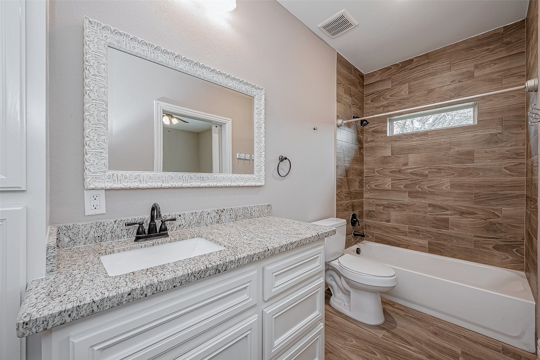 11 Bluebonnet Trinity, TX 75862 - Photo 24 of 46 a bathroom with a granite countertop sink toilet and shower