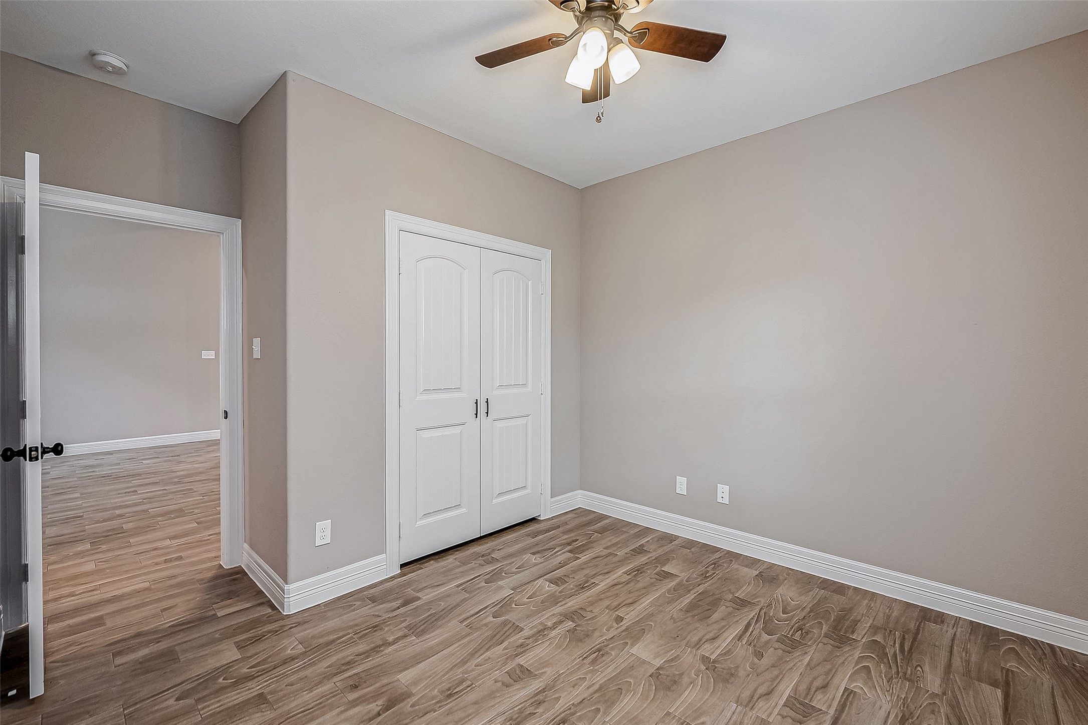 11 Bluebonnet Trinity, TX 75862 - Photo 25 of 46 an empty room with wooden floor and chandelier fan