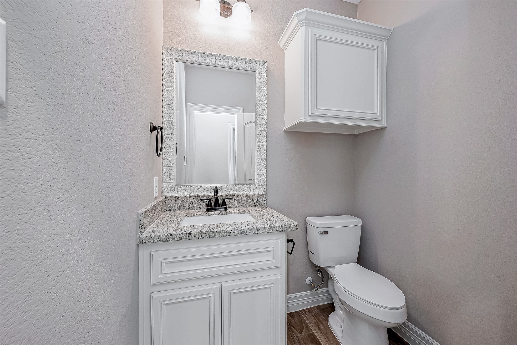 11 Bluebonnet Trinity, TX 75862 - Photo 26 of 46 a bathroom with a granite countertop toilet sink and mirror