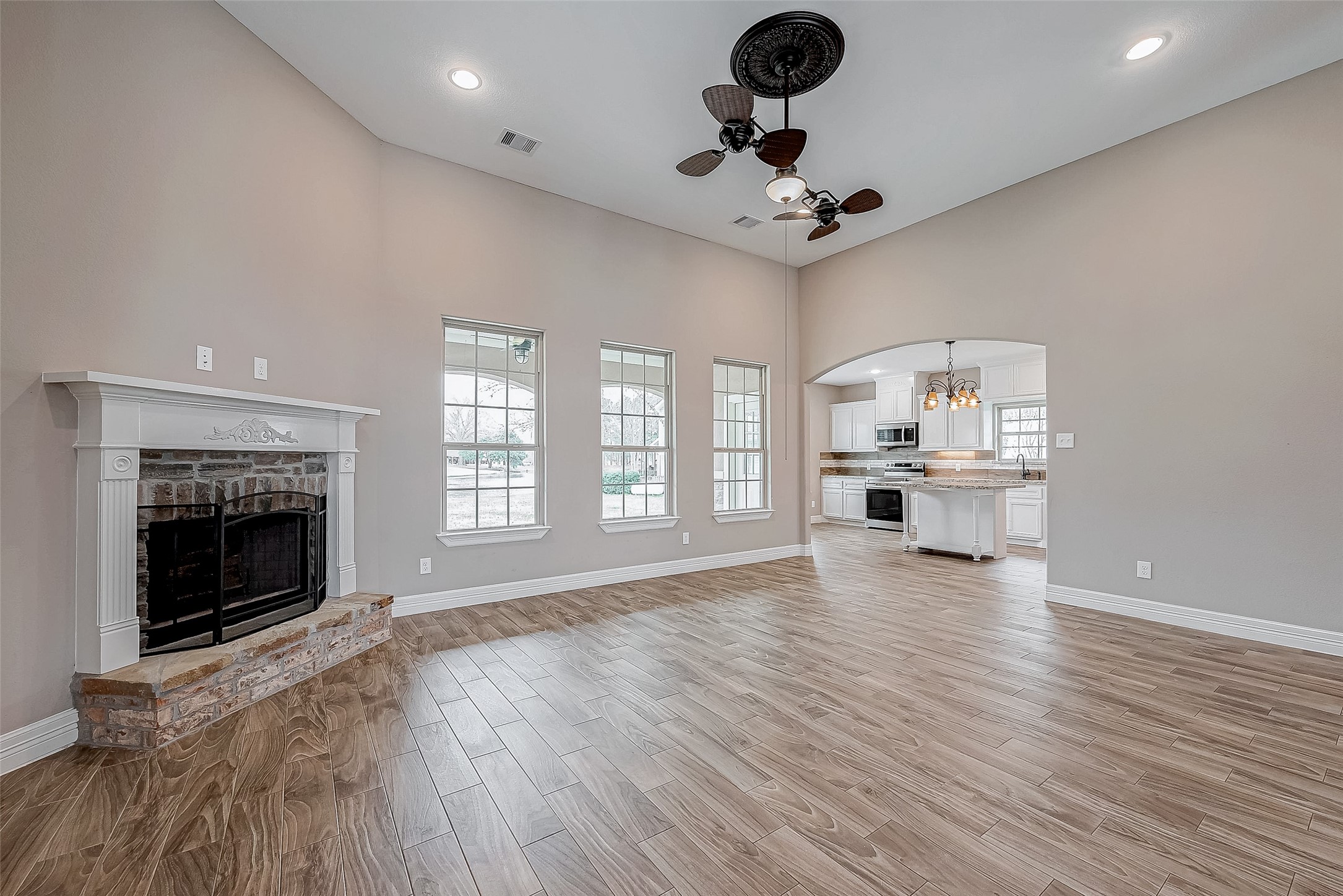 11 Bluebonnet Trinity, TX 75862 - Photo 10 of 46 a view of an empty room with a fireplace and wooden floor