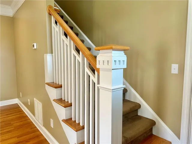 a view of entryway and hall with wooden floor