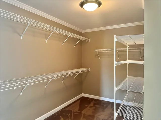 a view of a room with wooden floor and windows