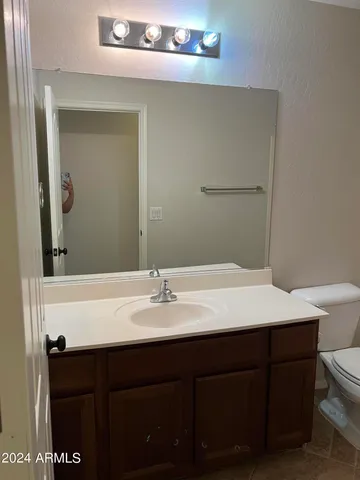 a bathroom with a sink vanity and a mirror