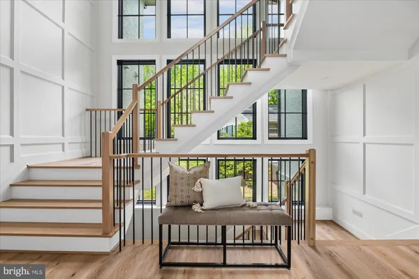 a living room with furniture and large windows