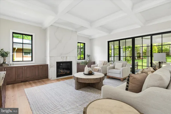 a kitchen with stainless steel appliances granite countertop a stove a sink a dining table and chairs with wooden floor