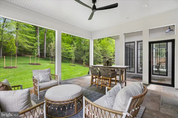 a view of a dining room with furniture large windows and wooden floor