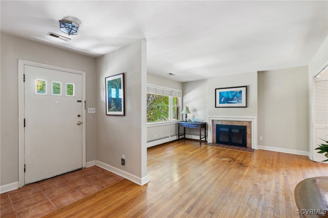 126 Beverly Road Ashland, VA 23005 - Photo 4 of 30 a view of a livingroom with wooden floor and a fireplace