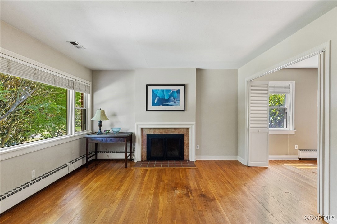 126 Beverly Road Ashland, VA 23005 - Photo 5 of 30 a view of empty room with floor to ceiling window and wooden floor