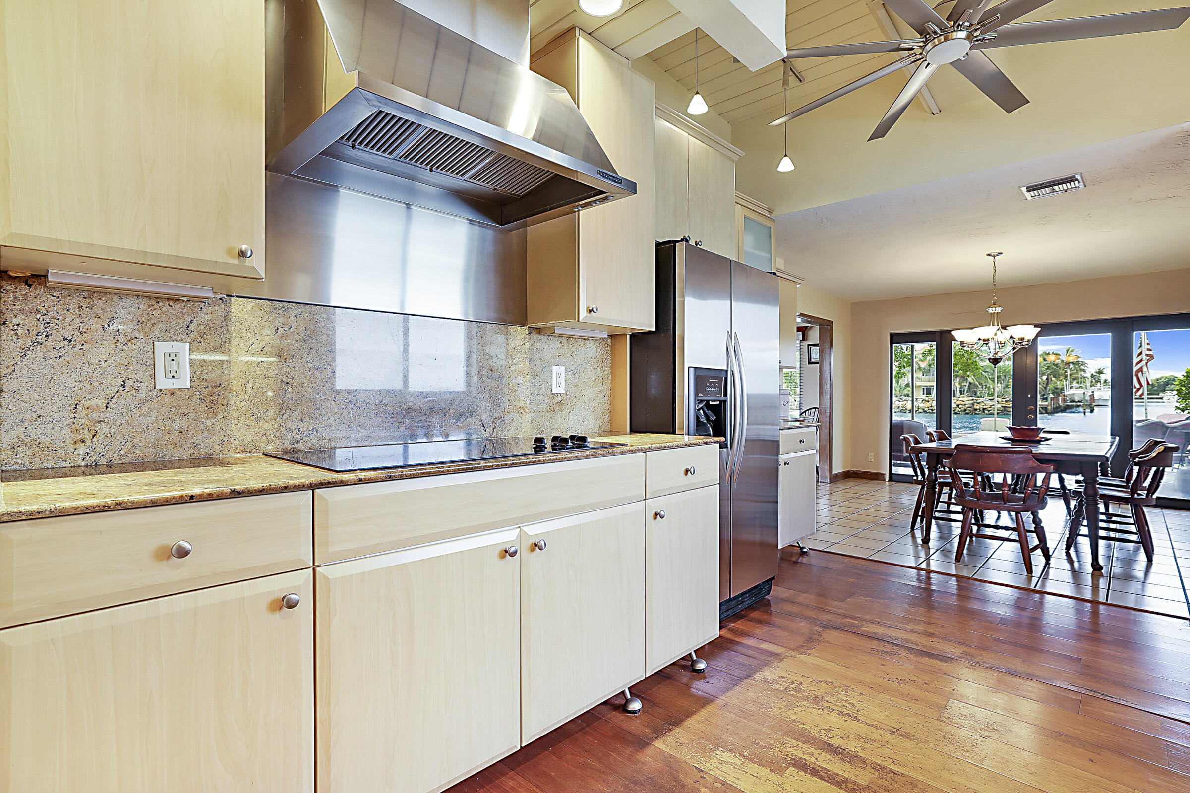 1901 North Riverside Drive Pompano Beach, FL 33062 - Photo 22 of 45 a kitchen with granite countertop a table chairs stove a sink and dishwasher