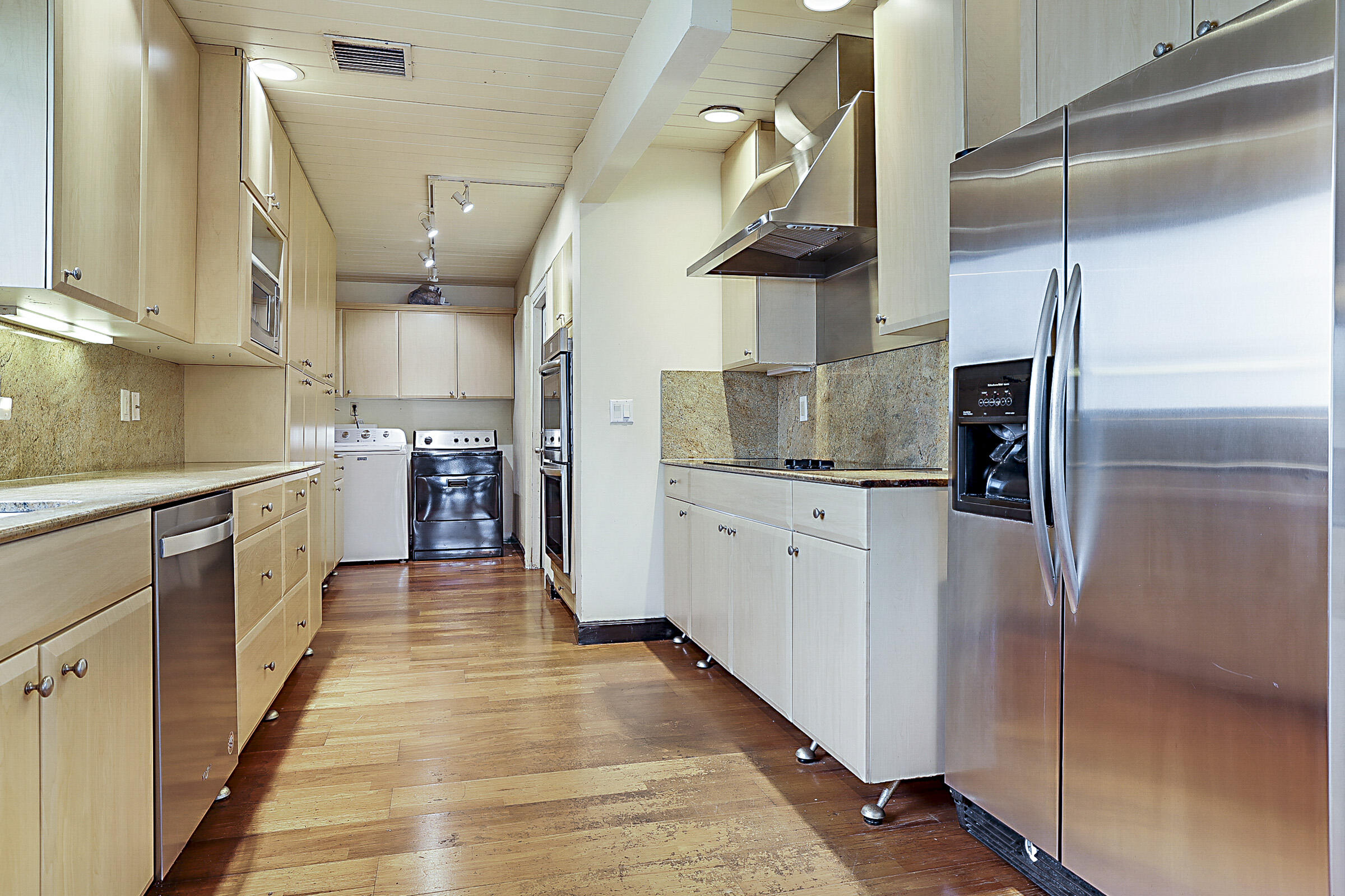 1901 North Riverside Drive Pompano Beach, FL 33062 - Photo 24 of 45 a kitchen with stainless steel appliances a refrigerator and a wooden floors