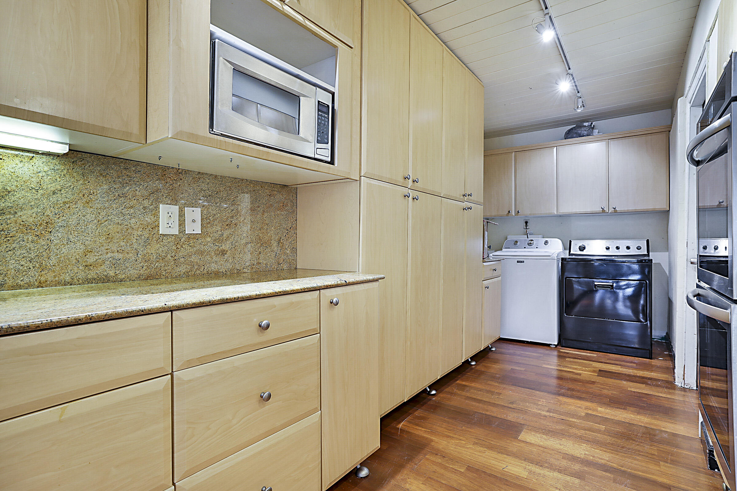 1901 North Riverside Drive Pompano Beach, FL 33062 - Photo 26 of 45 a kitchen with cabinets and wooden floor