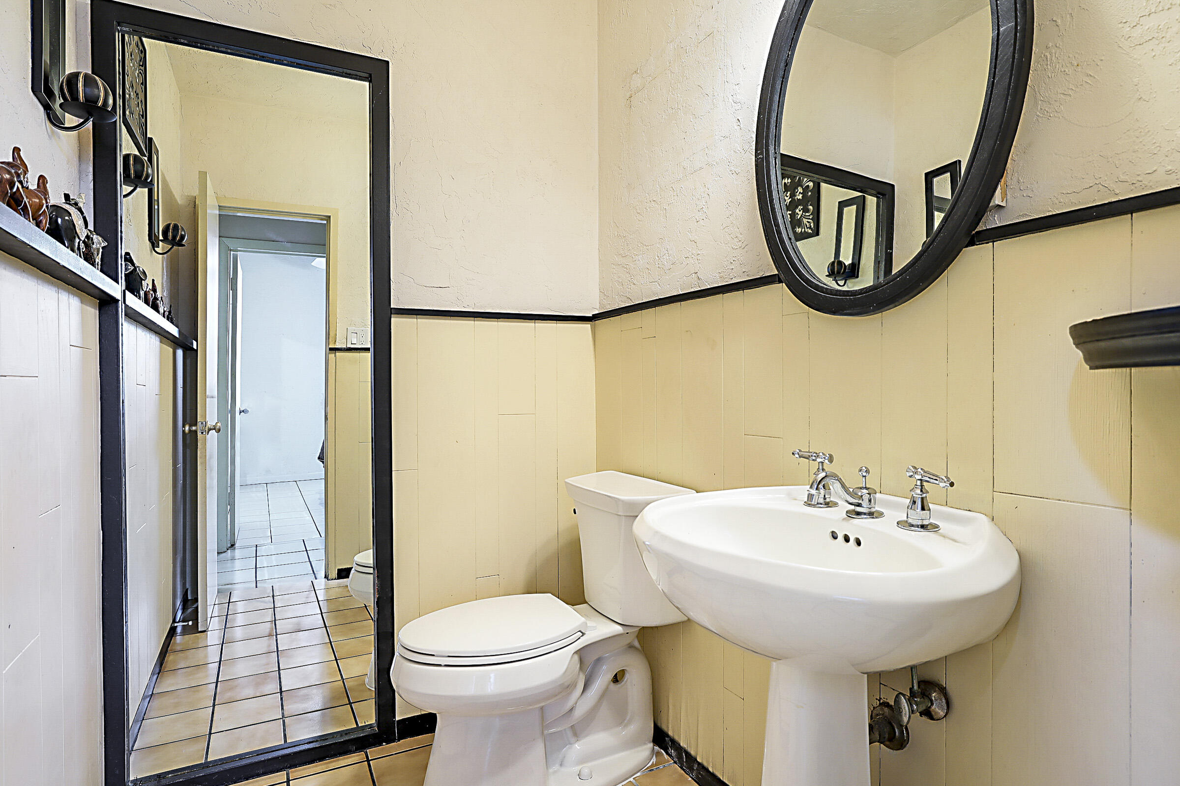 1901 North Riverside Drive Pompano Beach, FL 33062 - Photo 33 of 45 a bathroom with a sink and mirror